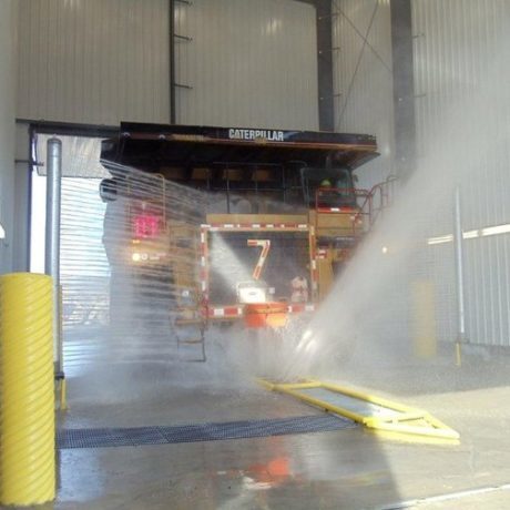 Truck wash with large industrial truck in tunnel