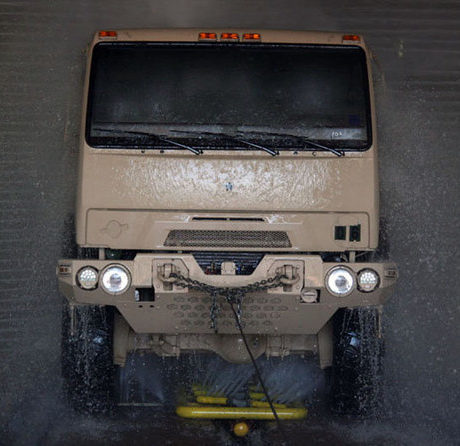 Military vehicle in fleet wash tunnel