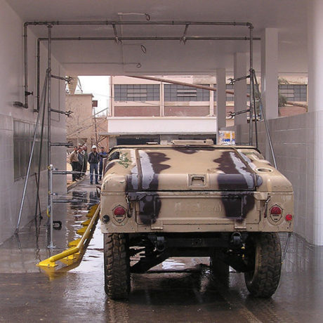 Military vehicle in fleet wash tunnel